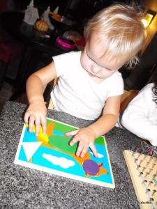 Bug using our Melissa & Doug shapes puzzles.  There are about a dozen different ones, but she always goes straight for the dog one!